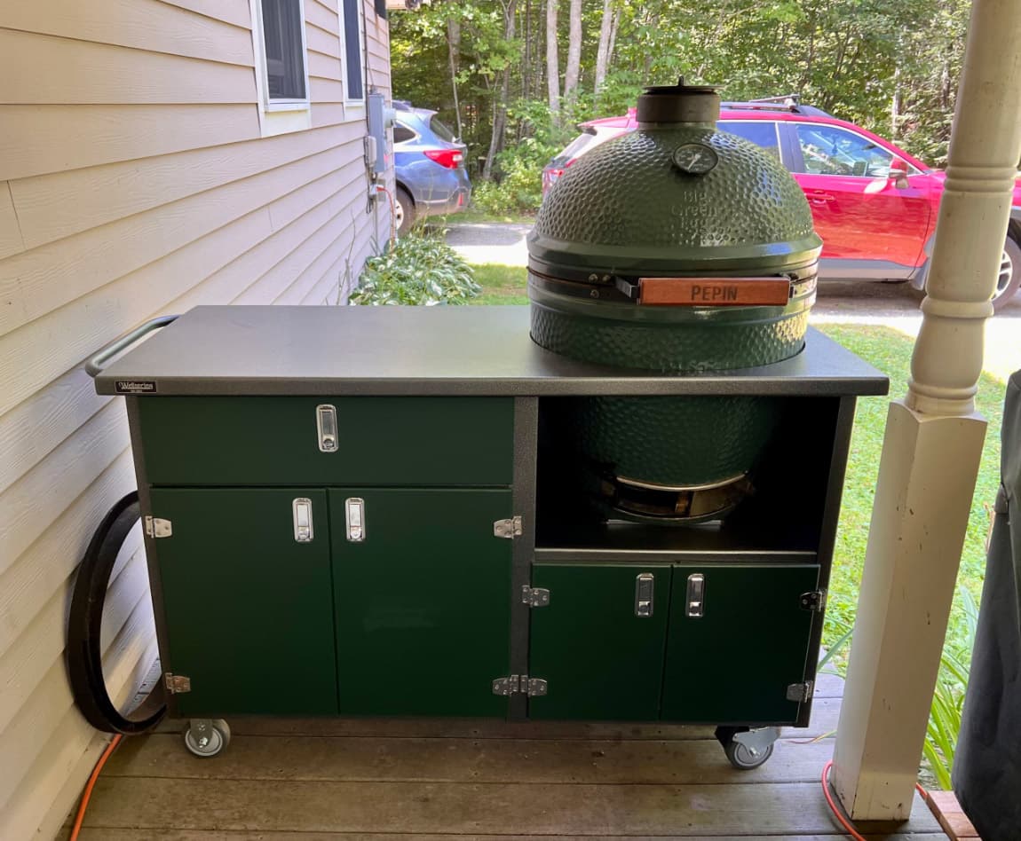 Green ceramic grill on outdoor grill cabinet