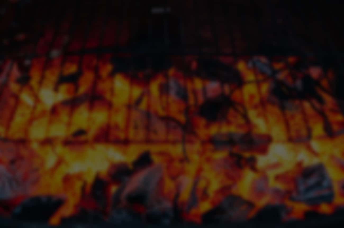 Blurred image of glowing hot charcoal embers.