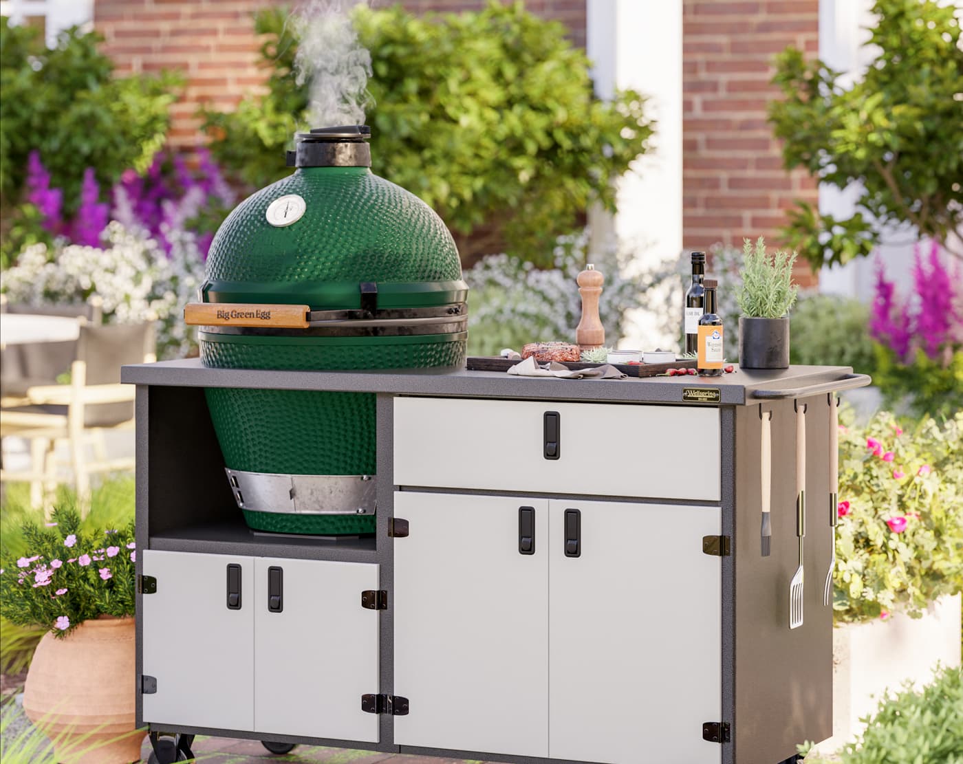 Green ceramic grill on outdoor kitchen cabinet