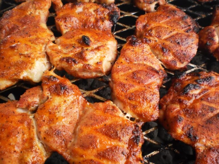 Grilled chicken breasts on barbecue grill.