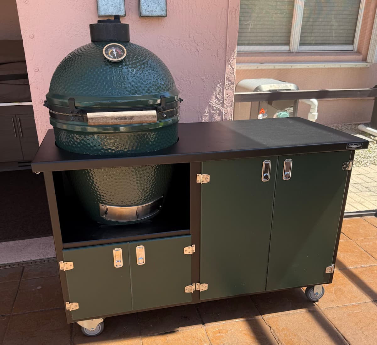 Big Green Egg in Alpha Series grill cabinet on a deck